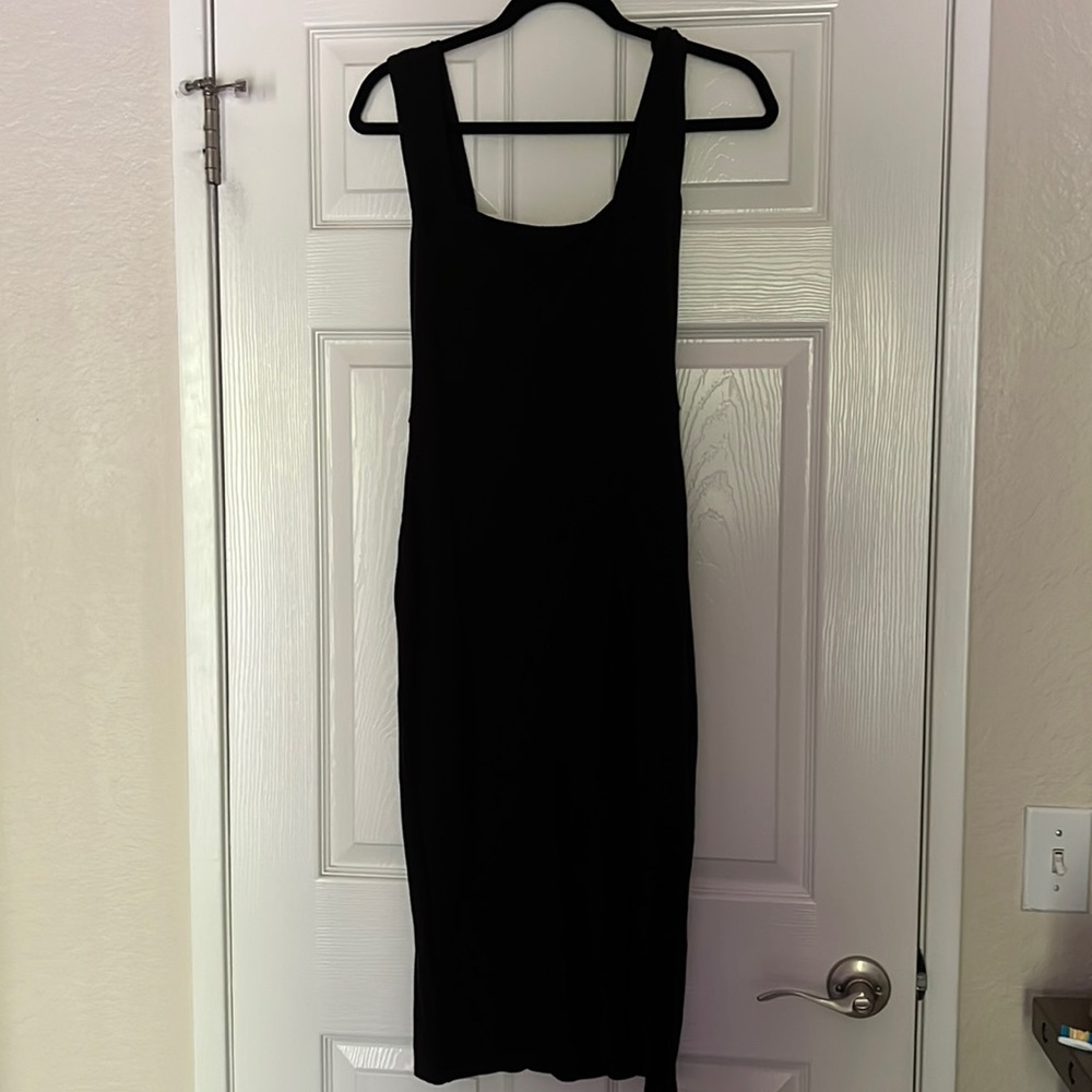 Black Cassi knit dress by reformation dress with a slit on the left side.